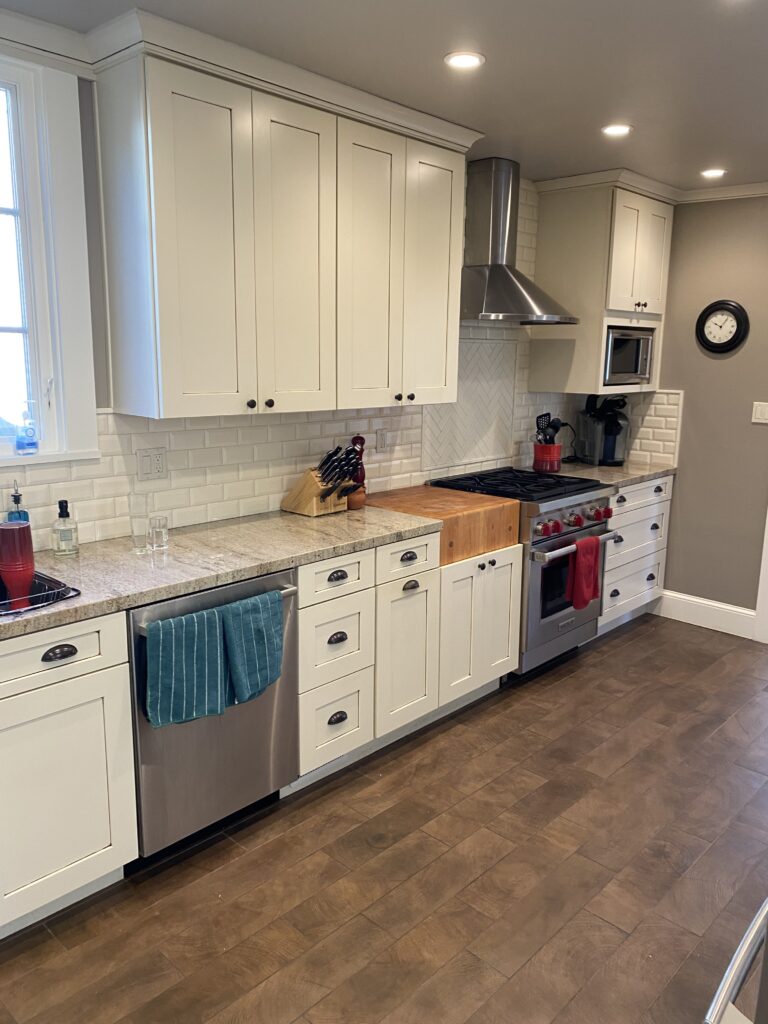 Kitchen remodeling in San Mateo County, CA, featuring white cabinetry and granite countertops